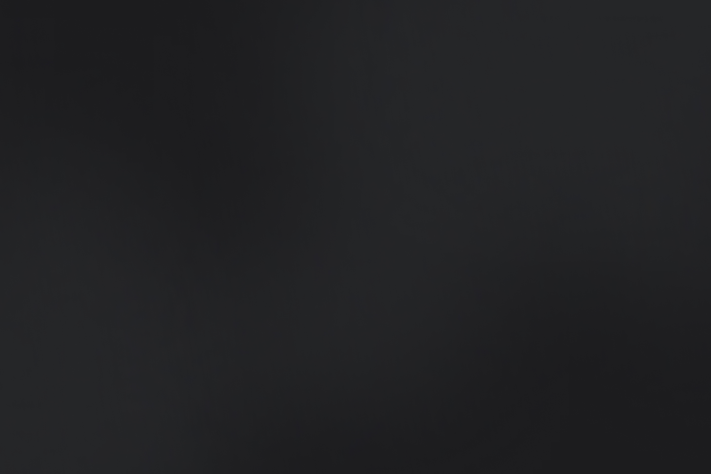 Dark grey and black gradient background.